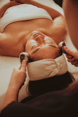 Female client at Dandle Spa receiving an ice globe massage during our organic facial