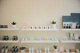 Dandle skincare products for sensitive skin lined up on white shelving