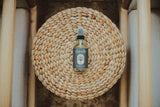 locally made, organic body oil from Dandle Spa and Skincare sitting on a wood surface