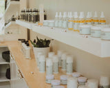Dandle organic skincare and body care products line up on white and wood shelves inside spa retail space in Chattanooga, TN