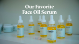 Bottles of Dandle antioxidant oil, rich orange colored serum from rosehip oil, sitting on a white shelf. Words "our favorite face oil serum" printed at top of photo.