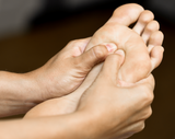 Two hands holding a foot giving a foot massage at Dandle Spa in Chattanooag