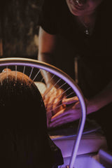 Woman under halo rinse at Chattanooga head spa