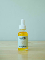 Antioxidant Face Oil sitting on wood surface. Organic face oil serum 