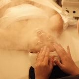 Female laying on a spa table getting a relaxing organic facial with steam at Dandle Spa in Chattanooga, TN