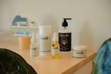 Dandle Skincare and body care products the healthy perimenopause skin sitting on a desk with a mirror