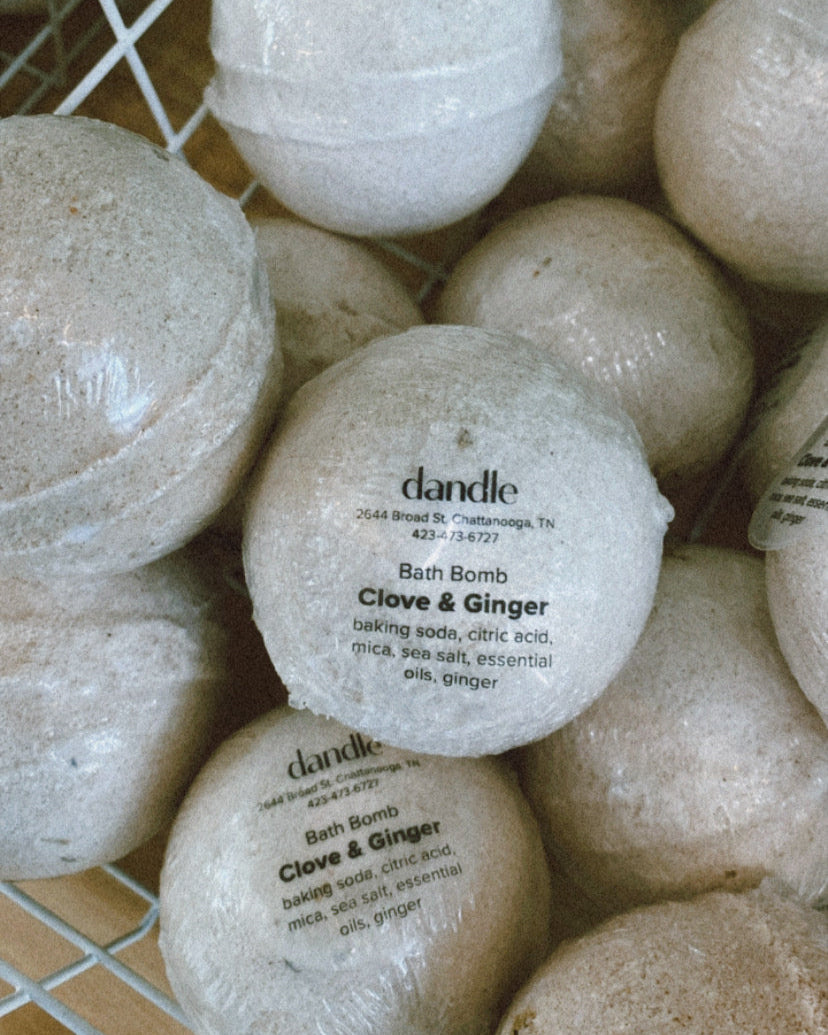 Bath bombs with visible branding on a wire rack