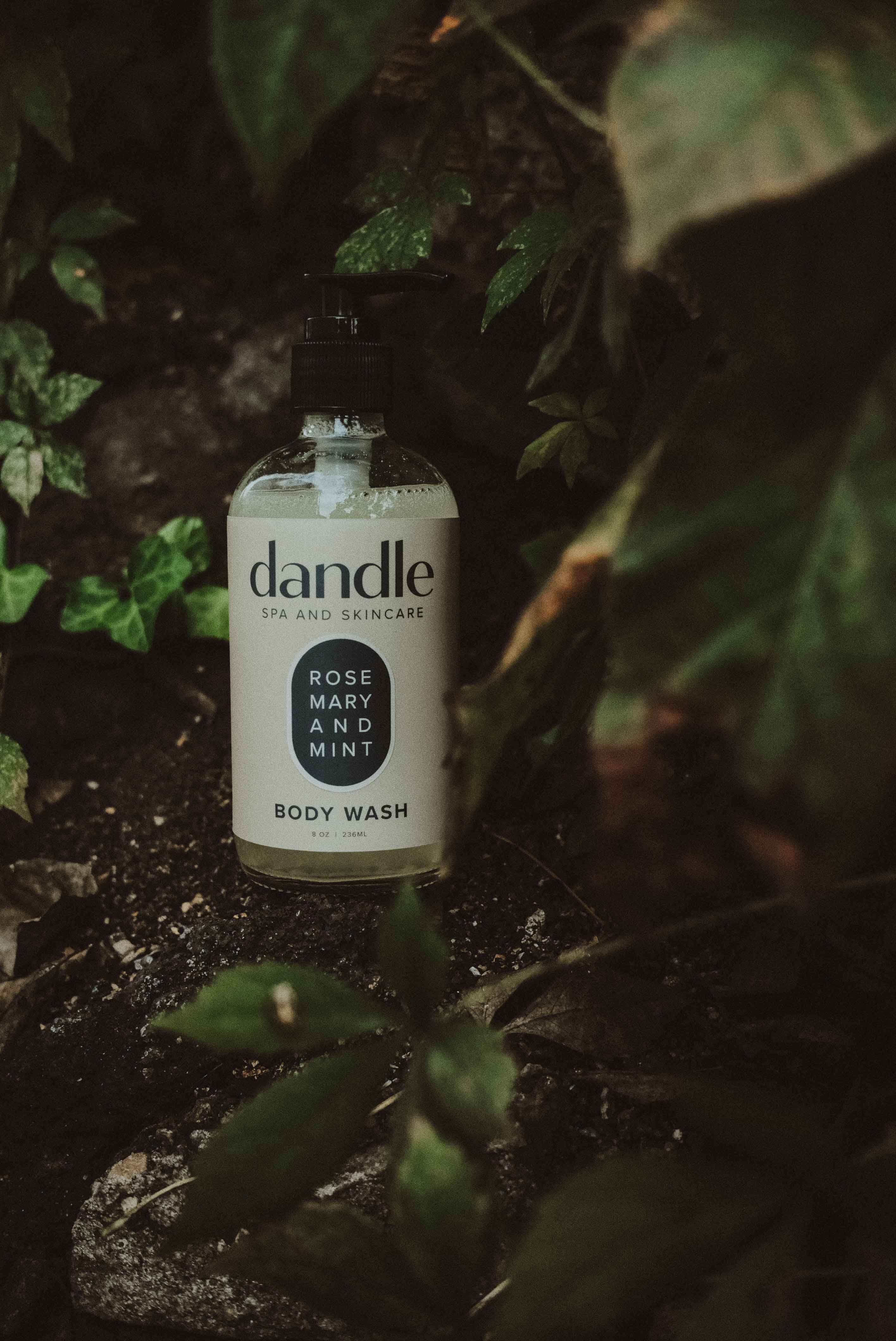 Dandle all-natural body wash bottle in a natural setting with green leaves. Soap made with essential oils. Tennessee product