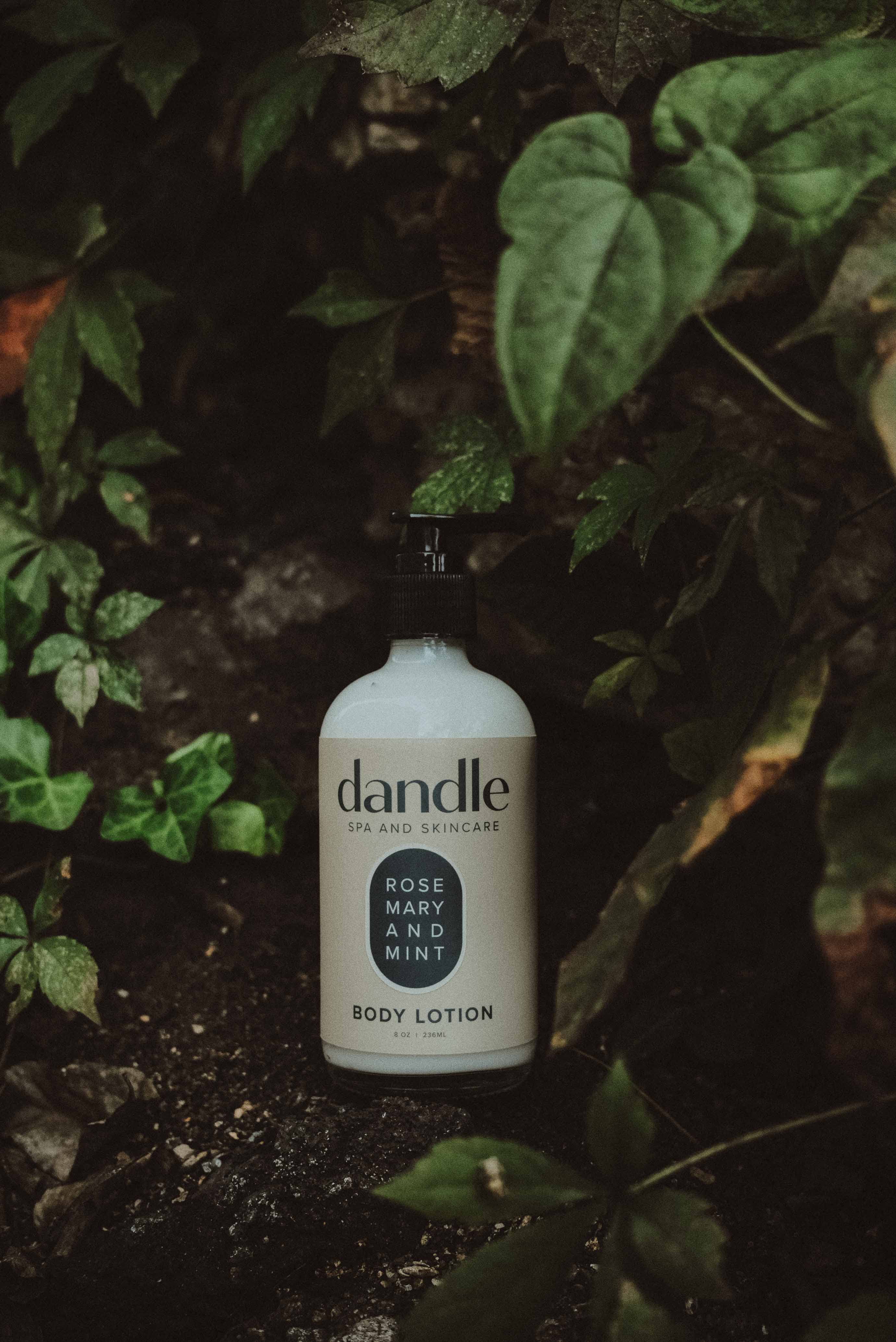 Dandle all-natural body lotion bottle among green leaves. Organic body lotion. Made in Chattanooga, TN