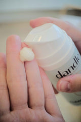 creamy organic face wash being pumped into hand from dandle all-natural skincare line.