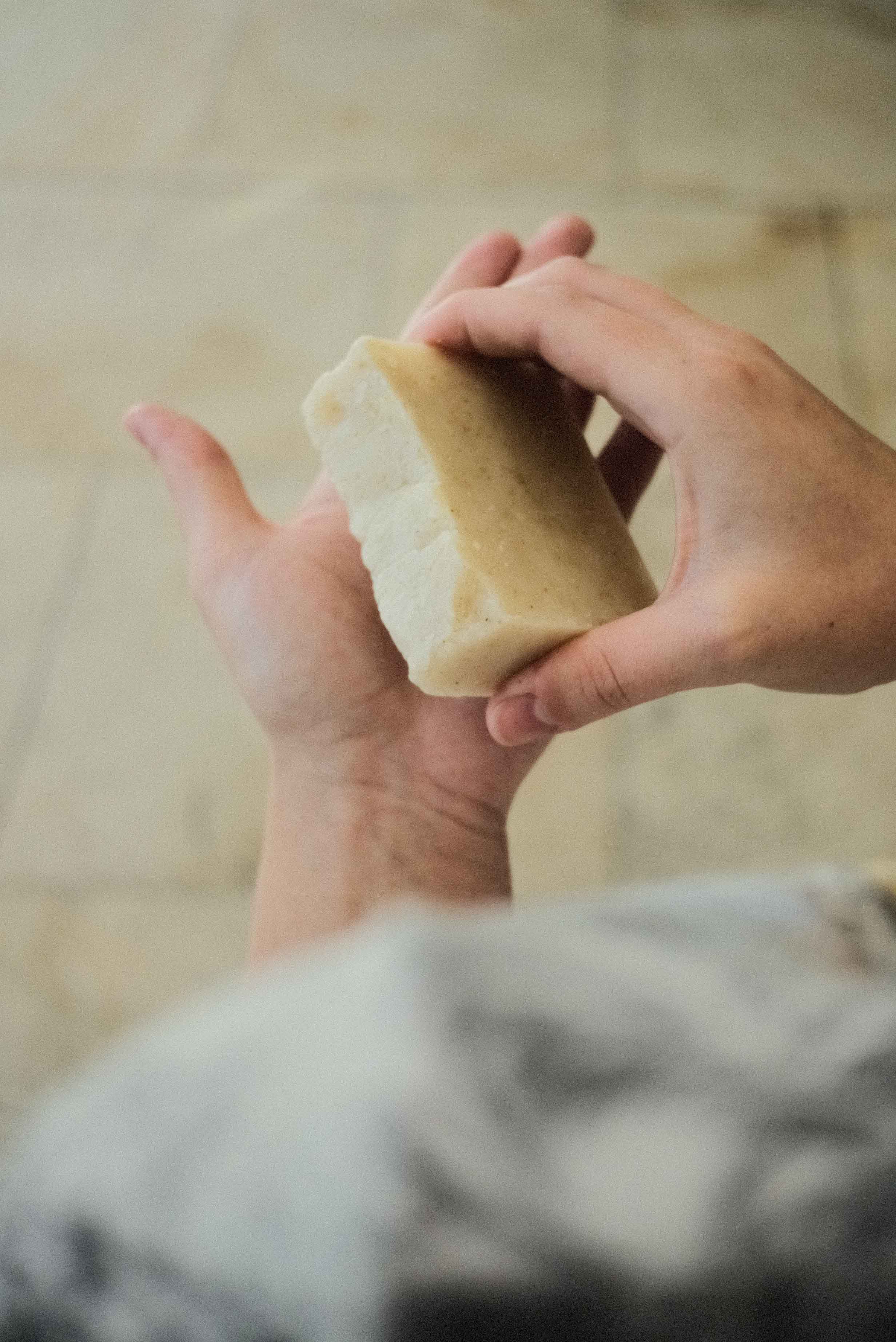 hands holding a bar of soap. Best organic bar soap made with essential oils. 