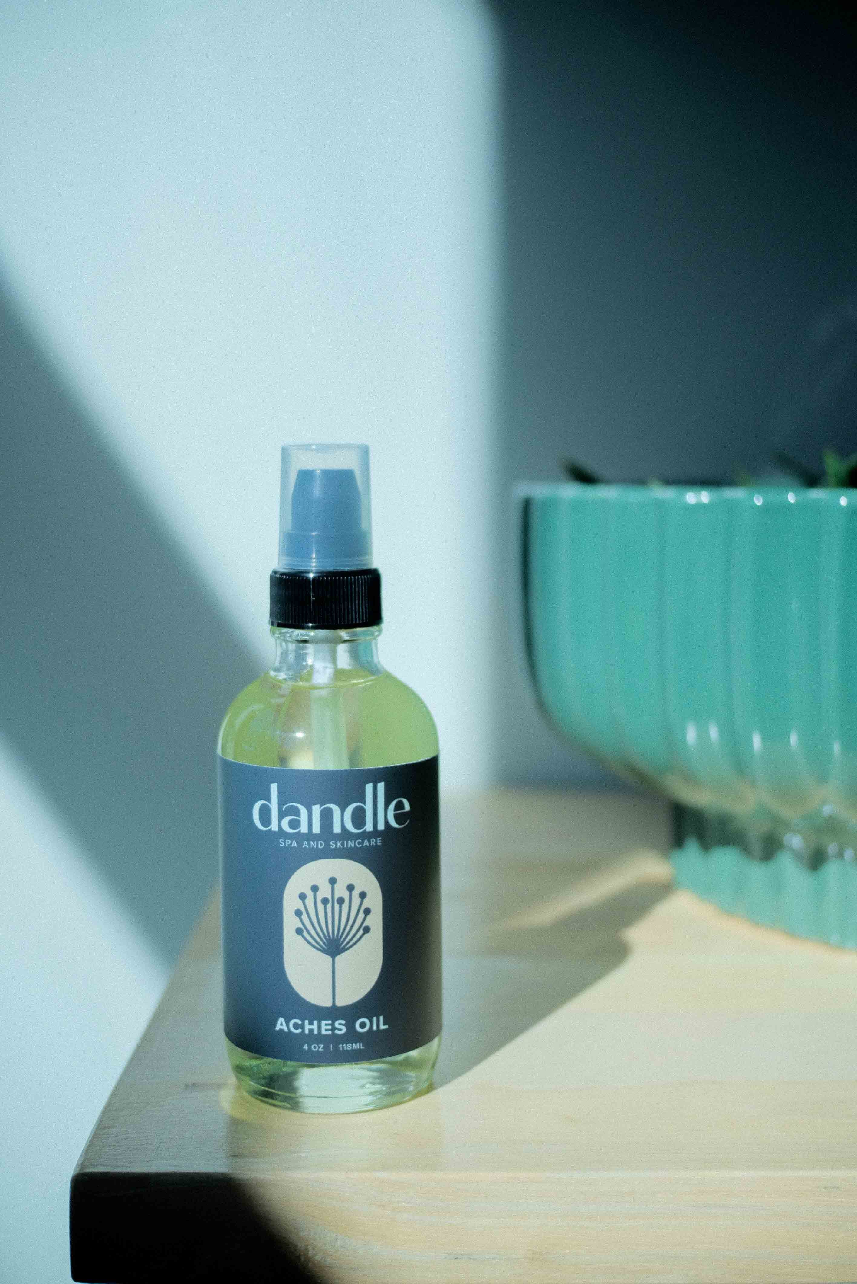 Bottle of dandle aches oil on a surface with a blurred background. Organic product for muscle pain and body aches. 