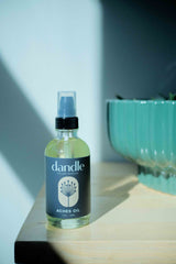Bottle of dandle aches oil on a surface with a blurred background. Organic product for muscle pain and body aches. 