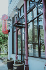 Storefront with decorative elements and a sign on a building exterior