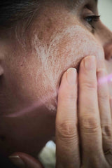 Close-up of female washing cheek with natural face wash. Best organic cleanser for dry skin