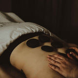 Person receiving hot stone massage in a Chattanooga Day spa, Dandle Spa and Skincare