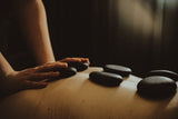 person receiving hot stone massage by chattanooga massage therapist