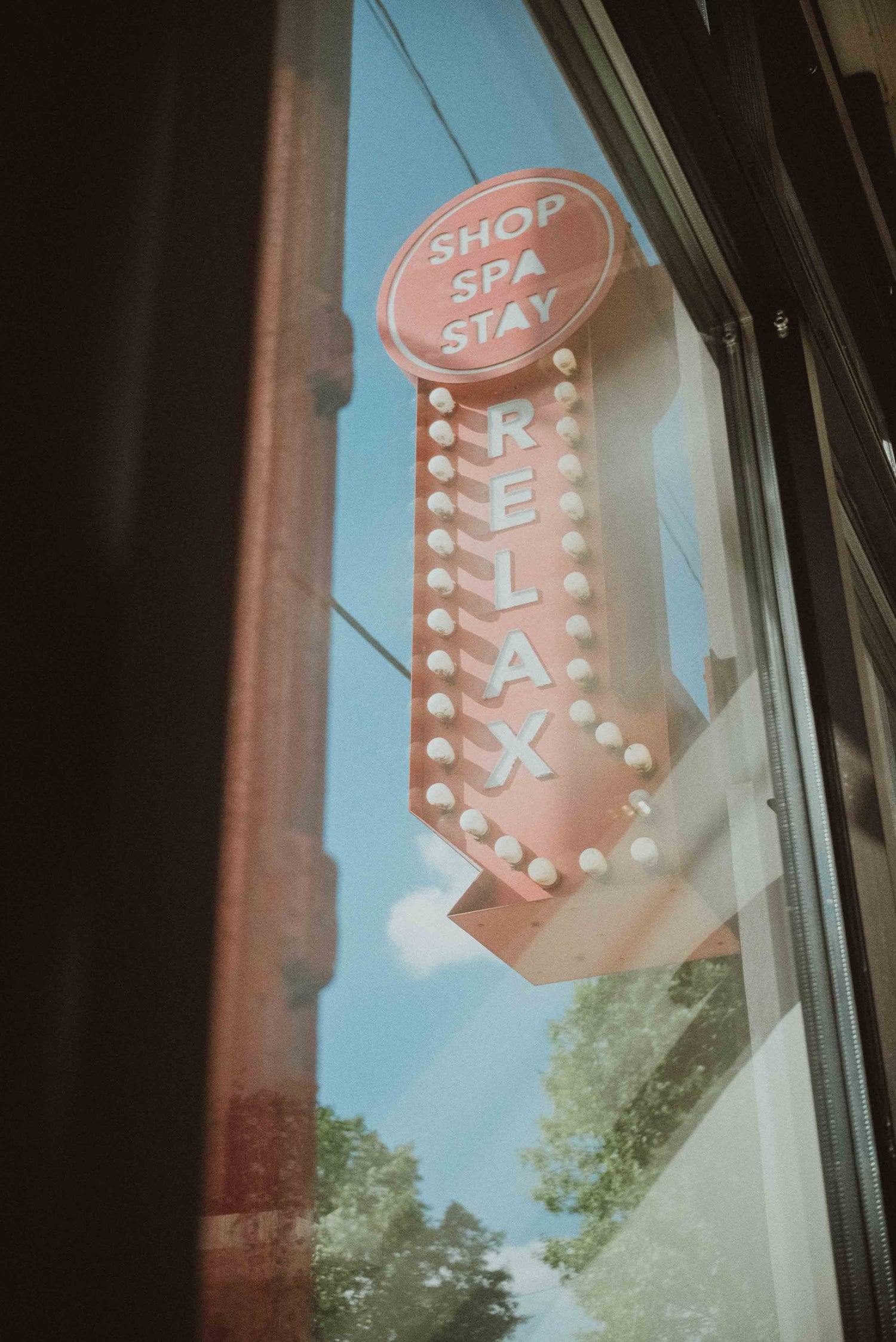 Large red arrow sign that says "shop spa stay" and "relax" pointing to spa entrance