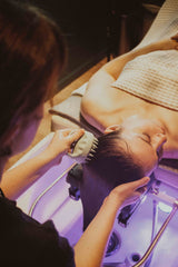 Person receiving a head spa service laying on back in day spa. Dandle has the best head spa in Chattanooga